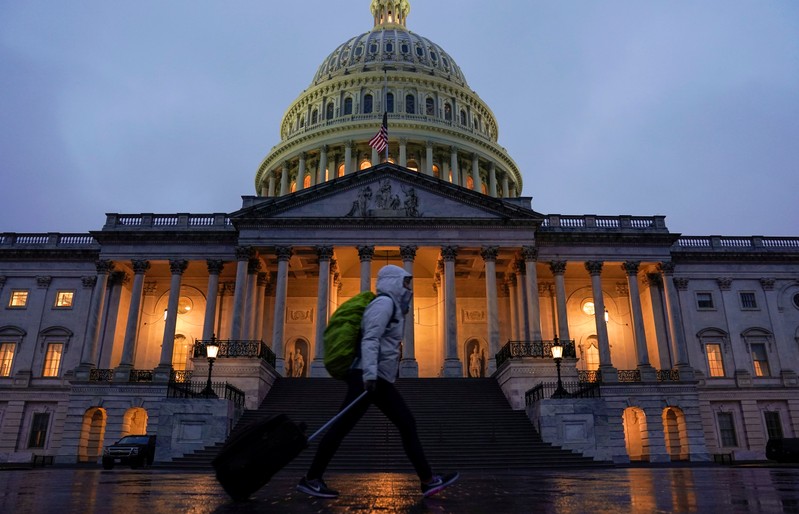 A pedestrian walk past the U.S. Capitol in Washington
