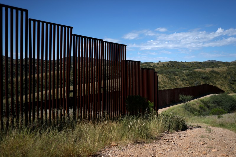 FILE PHOTO: Different generations of the U.S. border wall with Mexico are seen from the United States in Nogales, Arizona