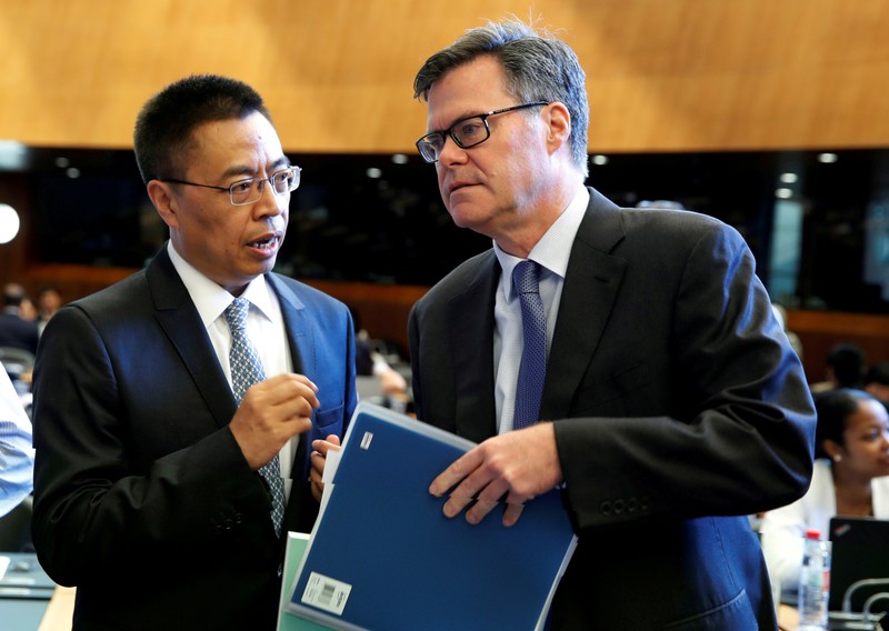 FILE PHOTO: Dennis Shea (R), U.S. Ambassador to the WTO, speaks with Chinese Ambassador Xiangchen Zhang before a World Trade Organization session in Geneva