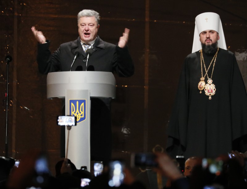 Ukraine's President Poroshenko congratulates newly elected head of the independent Ukrainian Orthodox church Metropolitan Epifaniy (Dumenko) at the Saint Sophia's Cathedral in Kiev