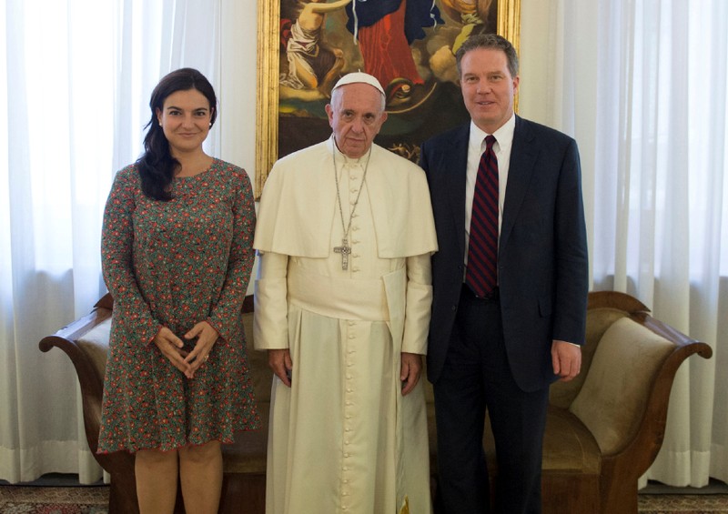 Pope Francis poses with Vatican spokesman Greg Burk and deputy Vatican spokesperson Paloma Garcia Ovejero during a meeting at the Vatican