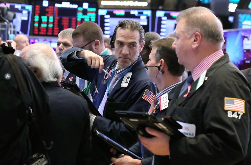 Traders work on the floor at the New York Stock Exchange (NYSE) in New York City