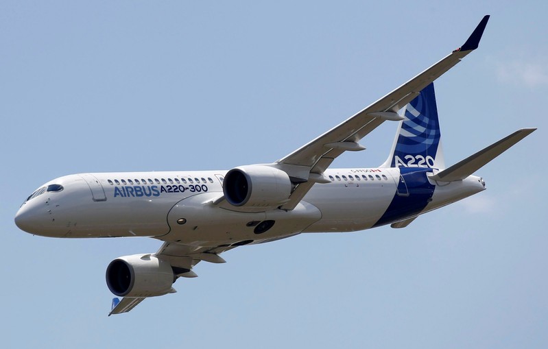 FILE PHOTO: An Airbus A220-300 aircraft flies during its unveiling in Colomiers near Toulouse