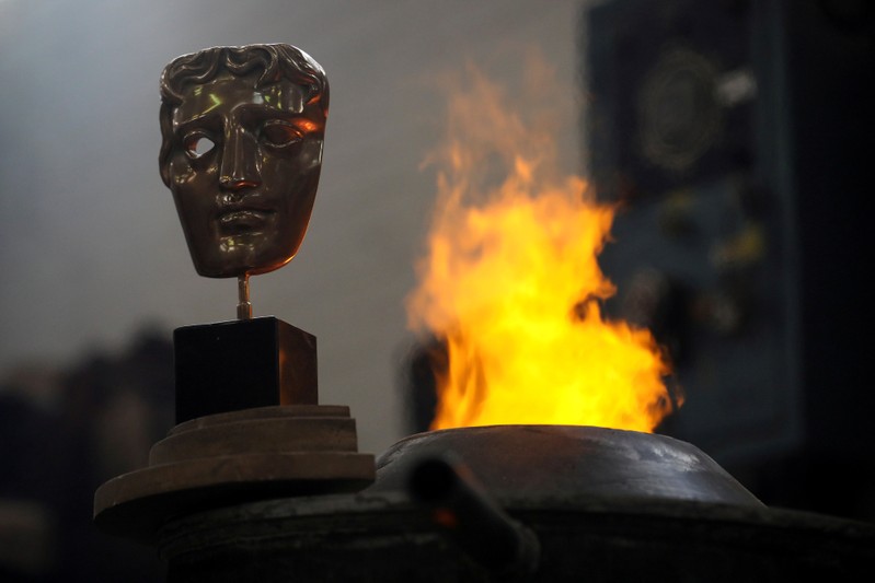 A completed British Academy of Film and Television Awards (BAFTA) mask is placed next to a furnace to be photographed at a foundry in west London