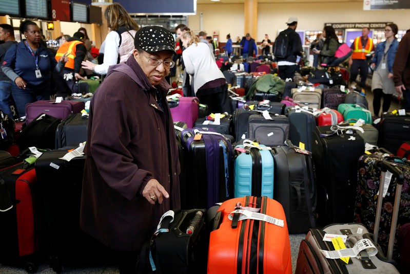 Passengers look for their luggage, after a paralyzing power outage, at Atlanta's Hartsfield-Jackson International Airport in Atlanta