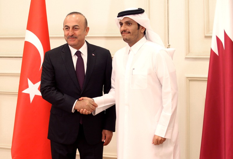 Qatari Foreign Minister Sheikh Mohammed bin Abdulrahman bin Jassim Al-Thani shakes hand with Turkish Foreign Minister Cavusoglu during their meeting in Doha