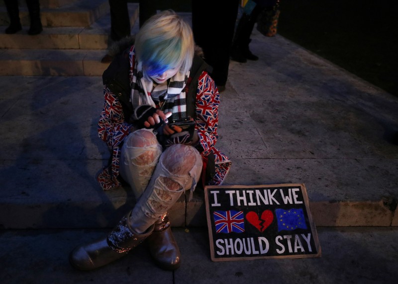 An anti-Brexit protester demonstrates outside the Houses of Parliament, in Westminster, London