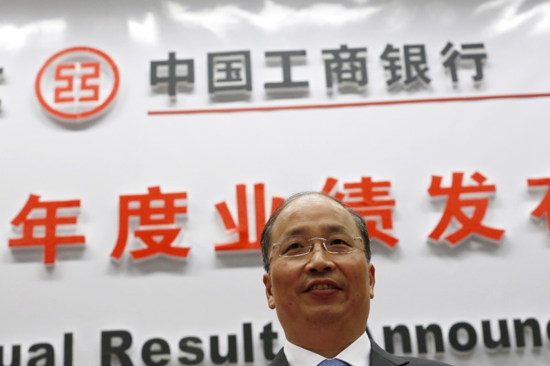 Industrial and Commercial Bank of China Ltd (ICBC)'s president Yi Huiman poses to photographers as he arrives at a news conference about its annual result announcement at its headquarters in Beijing