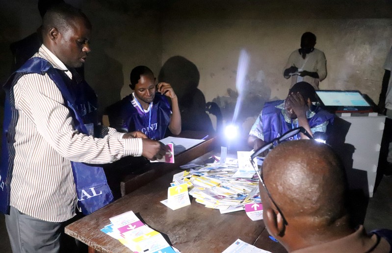 FILE PHOTO: Agents of Congo's National Independent Electoral Commission (CENI) count casted ballot papers after election at a polling station in Kinshasa