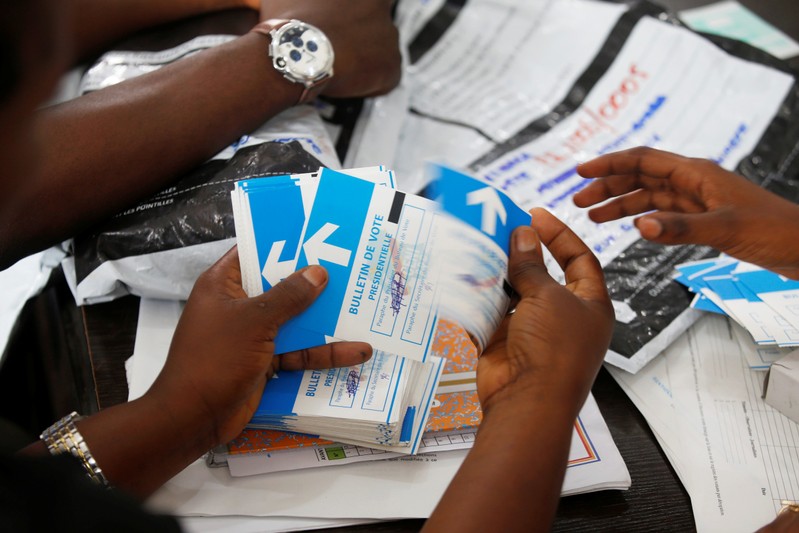 FILE PHOTO: Officials from Congo's Independent National Electoral Commission count presidential elections ballots at tallying centre in Kinshasa