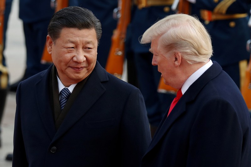 FILE PHOTO: U.S. President Donald Trump takes part in a welcoming ceremony with China's President Xi Jinping at the Great Hall of the People in Beijing