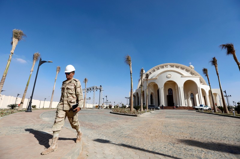 A member of Egyptian Army walks outside the new Coptic Cathedral 