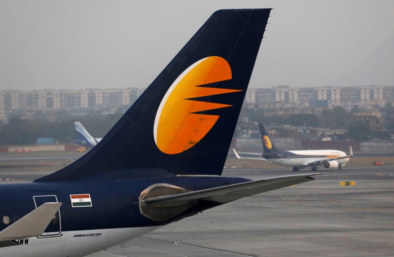 FILE PHOTO: A Jet Airways plane is parked as another moves to runway at the Chhatrapati Shivaji International airport in Mumbai