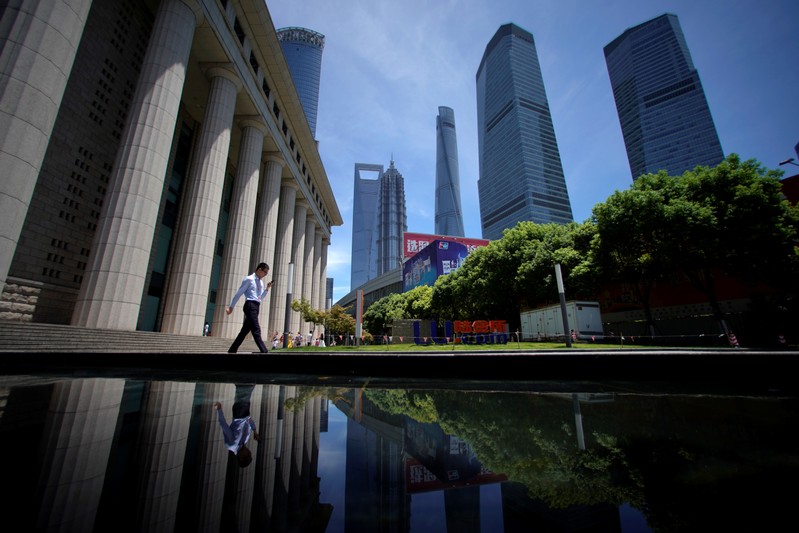 A man walks at Lujiazui financial district of Pudong in Shanghai