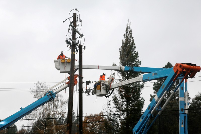 FILE PHOTO: PG&E crew work on power lines to repair damage caused by the Camp Fire in Paradise,