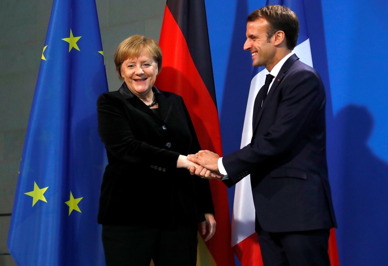 French President Macron and German Chancellor Merkel speak to reporters ahead of their meeting in Berlin