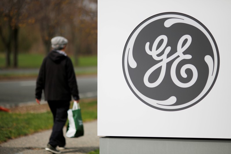 FILE PHOTO: A pedestrian walks past a General Electric facility in Medford