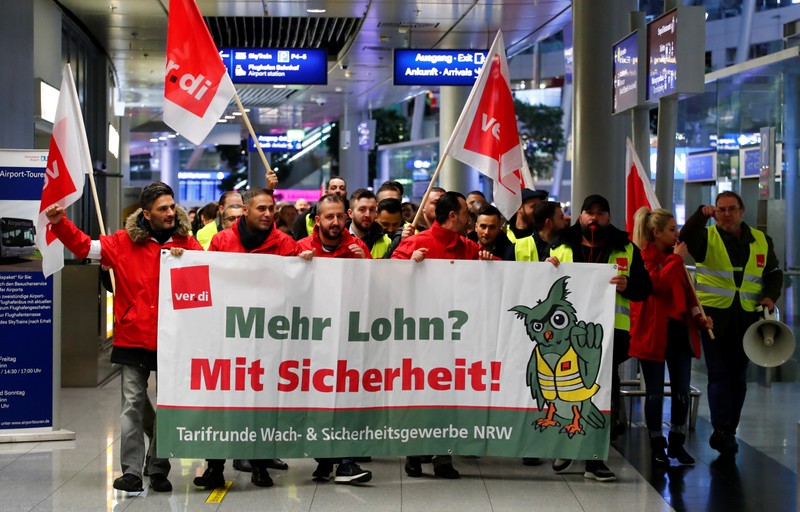 Employees of Duesseldorf Airport march through the main hall during a strike by German union Verdi, which called on security staff at Duesseldorf, Cologne and Stuttgart airports to put pressure on management in wage tal