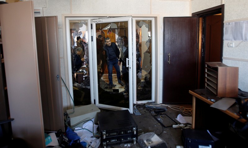 FILE PHOTO: Palestinians inspect the damage inside the office of Palestine TV, in Gaza City