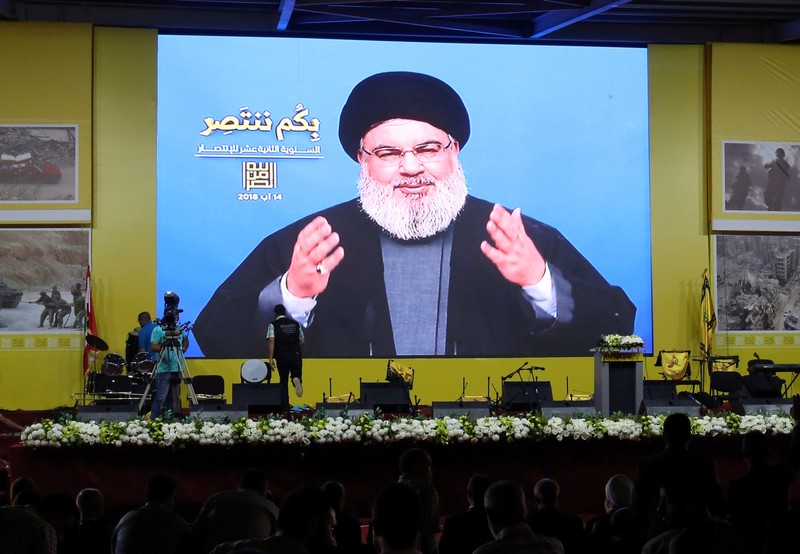 Lebanon's Hezbollah leader Sayyed Hassan Nasrallah gestures as he addresses his supporters via a screen in Beirut