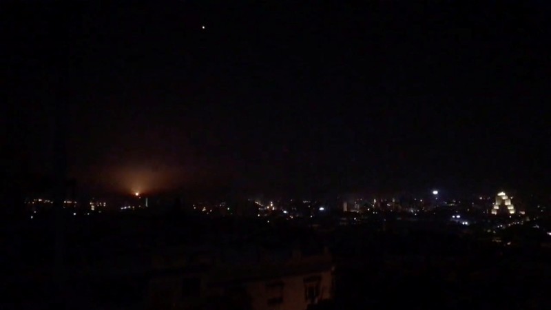 What is believed to be guided missiles are seen in the sky during what is reported to be an attack in Damascus
