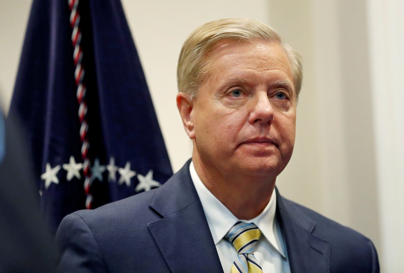 FILE PHOTO: Sen. Lindsey Graham (R-SC) waits for U.S. President Donald Trump to enter the room to speak about the 