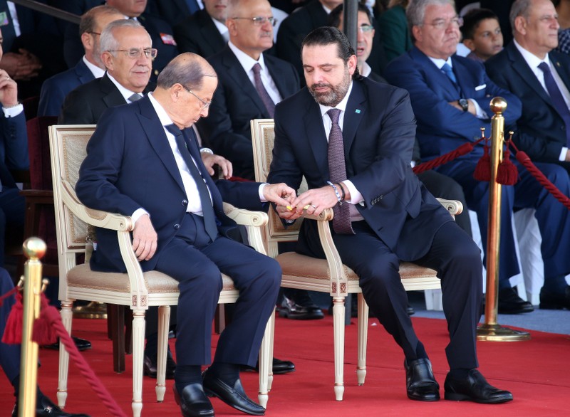 FILE PHOTO: Lebanese President Michel Aoun and Lebanese Prime Minister-designate Saad al-Hariri attend a military parade to celebrate the 75th anniversary of Lebanon's independence in downtown Beirut