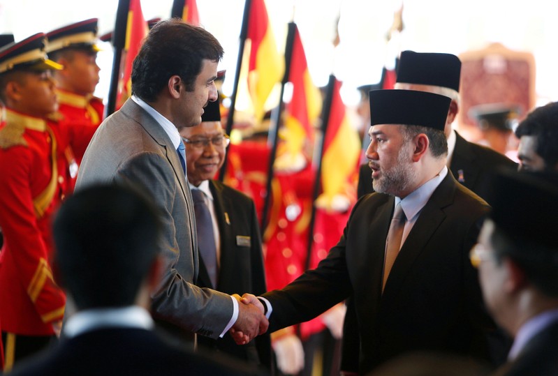 FILE PHOTO: Qatar's Emir Sheikh Tamim bin Hamad al-Thani shakes hand with Malaysia's King Muhammad V after a state welcome ceremony at the Parliament House in Kuala Lumpur