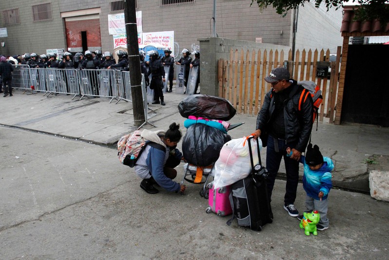 FILE PHOTO: Migrants leave a temporary shelter voluntarily in Tijuana