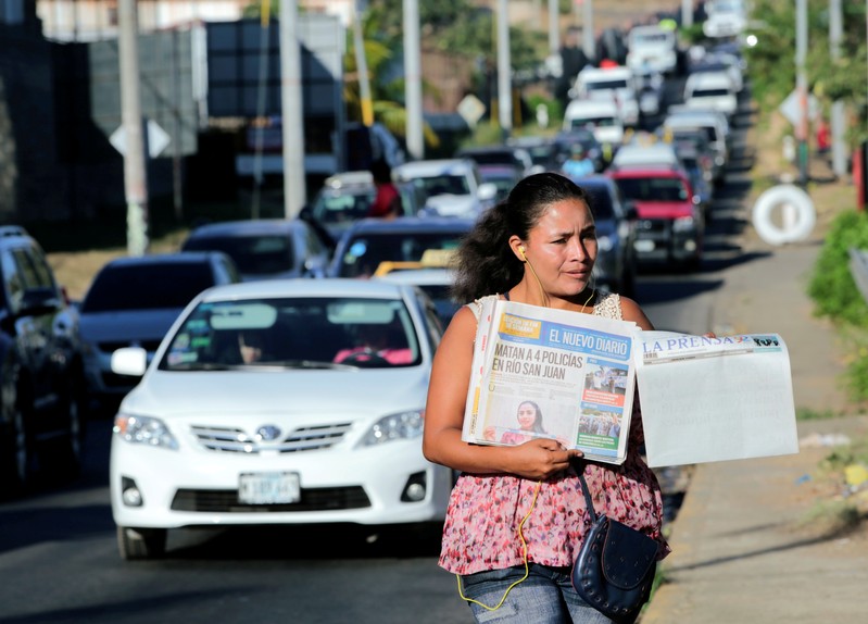 FILE PHOTO: A street vendor sells La Prensa, a local newspaper showing a blank front page as a sign of protest against Daniel Ortega's government, in Managua