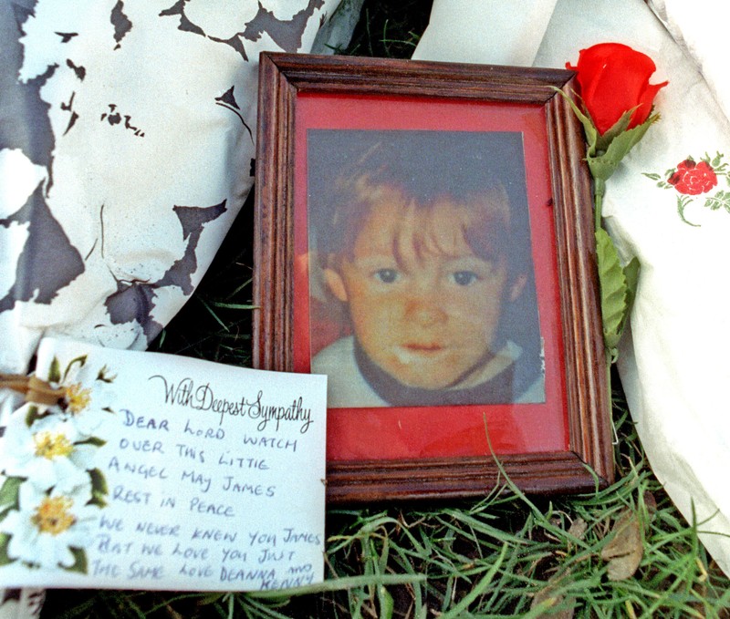 File photo shows photograph of murdered toddler Bulger among floral tributes in Liverpool