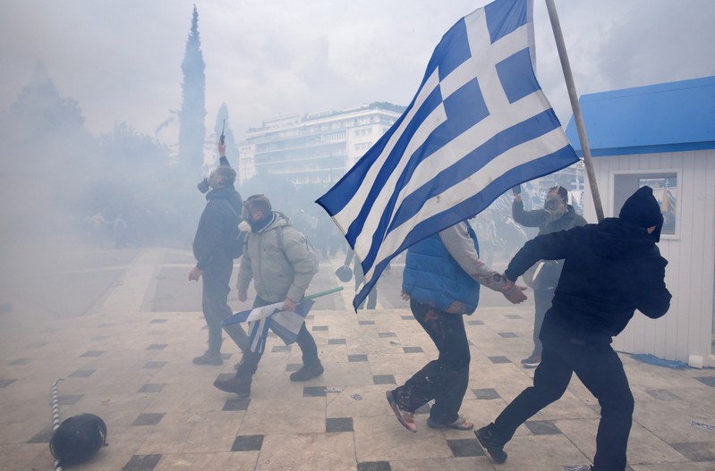 Protesters clash with police officers during a demonstration against the agreement reached by Greece and Macedonia to resolve a dispute over the former Yugoslav republic's name, in Athens