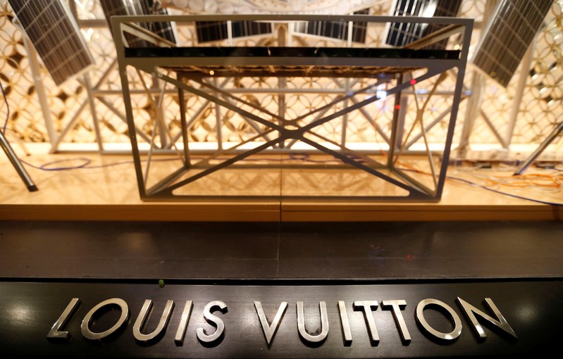 The logo of the Louis Vuitton brand is seen outside a Louis Vuitton store in Paris