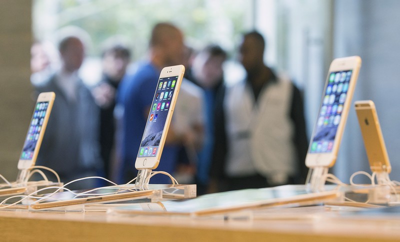 Customers stand in line at the Apple store in Berlin, as they wait to buy the newly released iPhone 6