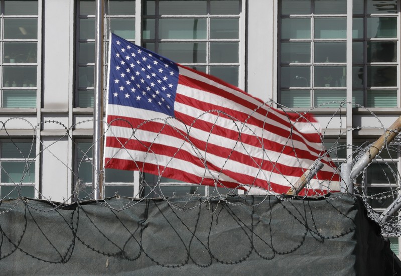 FILE PHOTO: A flag flies behind an enclosure on the territory of the U.S. embassy in Moscow