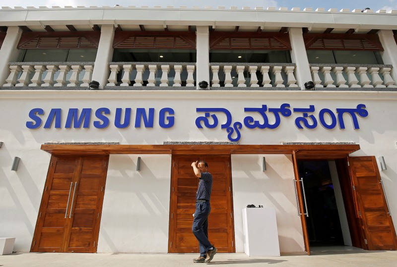 A man walks past a newly opened Samsung store in Bengaluru