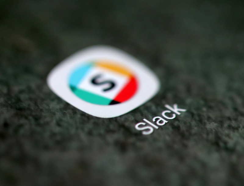 The Slack app logo is seen on a smartphone in this illustration