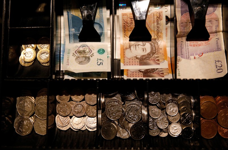 FILE PHOTO - Pound Sterling notes and change are seen inside a cash resgister in a coffee shop in Manchester
