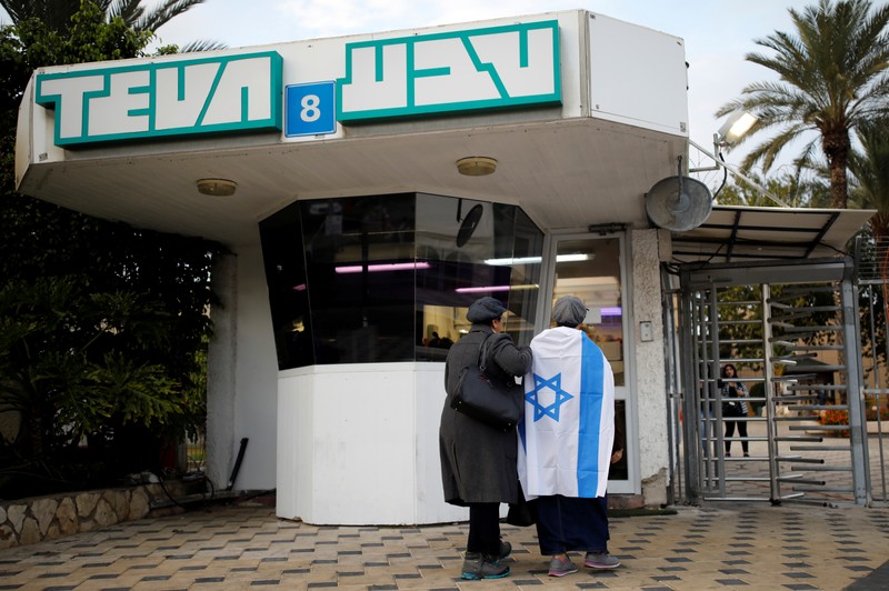 Workers of Teva Pharmaceutical Industries stand at the entrance to their facility in Ashdod, Israel