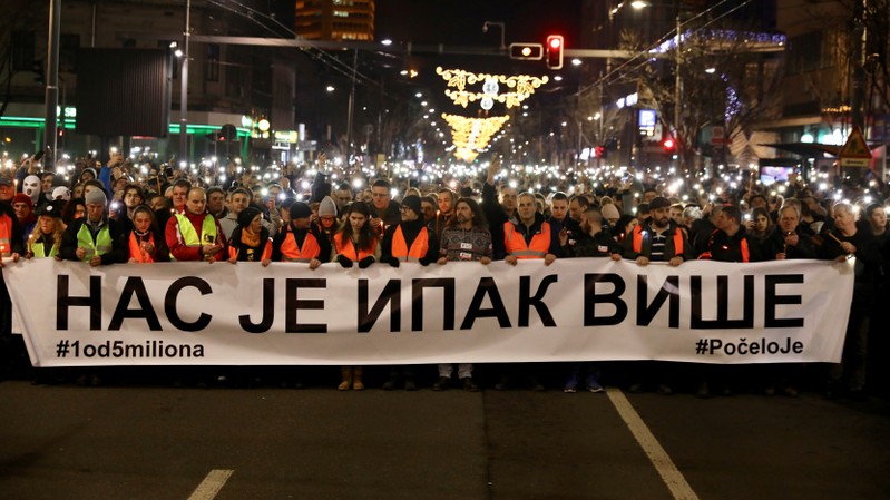 People attend a march on the first anniversary of the murder of opposition Serb politician Oliver Ivanovic, in Belgrade