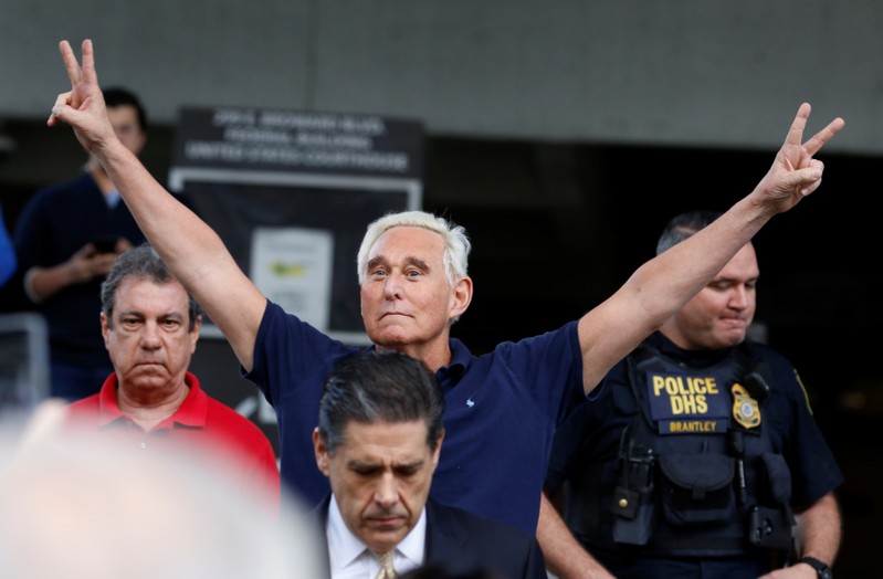Roger Stone reacts as he walks to microphones after his appearance at Federal Court in Fort Lauderdale