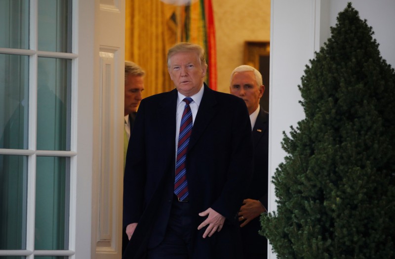 President Trump walks out of Oval Office to speak to reporters after meeting with members of Congress at the White House in Washington