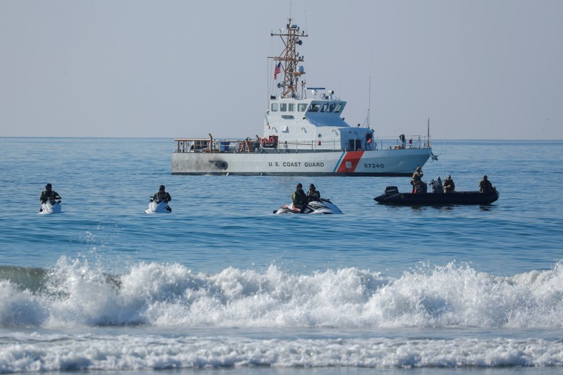 U.S. Border agents and the Coast Guard patrol the Pacific Ocean where the U.S. Mexico border wall enters the water at Border Field State Park in San Diego