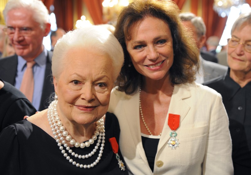 Actresses Bisset and de Havilland pose together after they were awarded with the Legion d'honneur in Paris