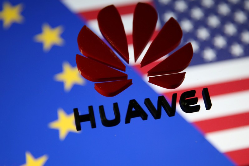 FILE PHOTO: A 3D printed Huawei logo is placed on glass above displayed EU and US flags in this illustration