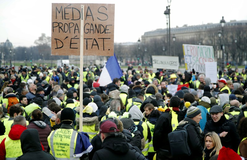 Protesters wearing yellow vests take part in a demonstration by the 
