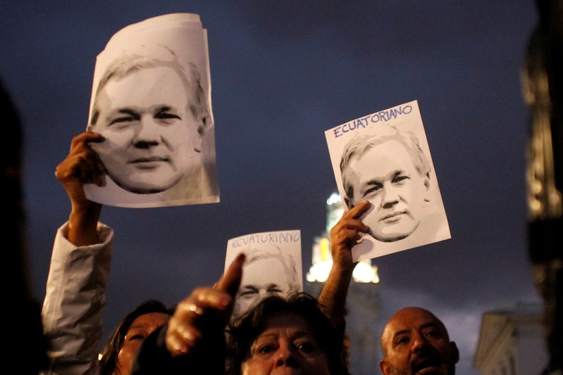 FILE PHOTO: Supporters of WikiLeaks founder Assange demonstrate in front of presidential palace regarding his Ecuadorian citizenship in Quito