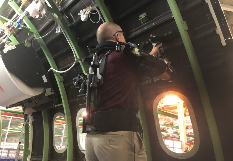 Employee Rob Gross gets a boost from a gas-powered exoskeleton Boeing is using to boost productivity and safety at their production factory in North Charleston