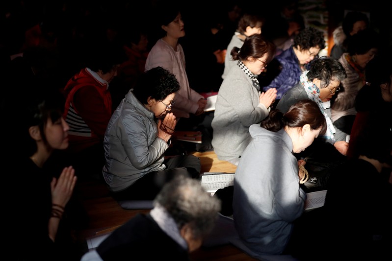 FILE PHOTO: Parents pray for their children's success in the college entrance examinations at a Buddhist temple in Seoul