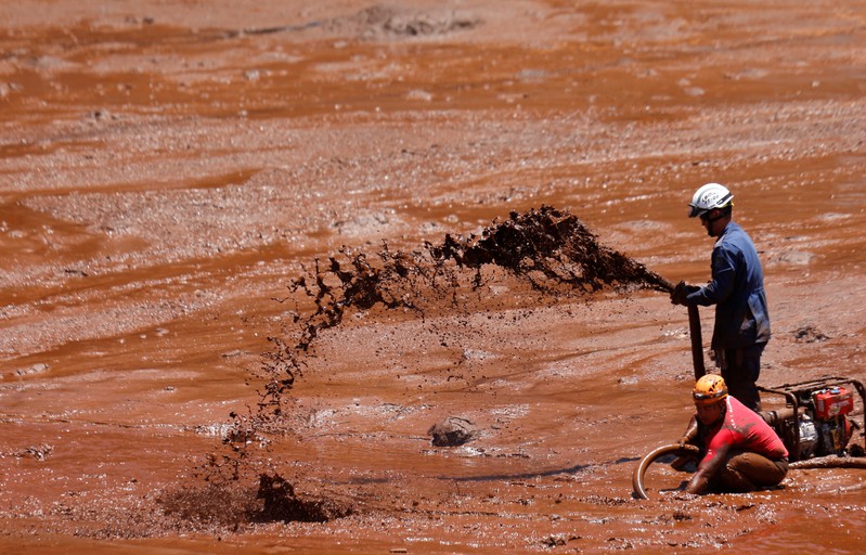 Rescue workers search for victims of a collapsed tailings dam owned by Brazilian mining company Vale SA, in Brumadinho